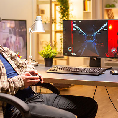 Professional gamer man using vr headset to play on powerful pc late at night