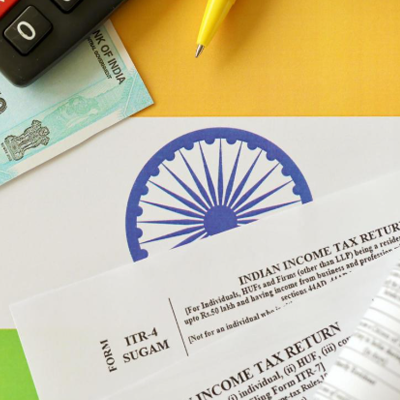 Indian income tax return blank form with pen and indian rupees bills