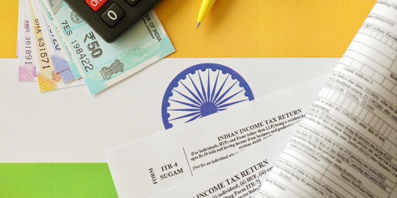 Indian income tax return blank form with pen and indian rupees bills