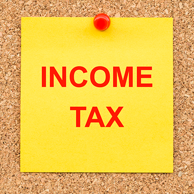 Yellow blank note and written Income TAX for reminder
