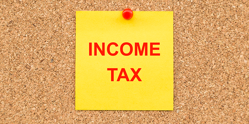 Yellow blank note and written Income TAX for reminder